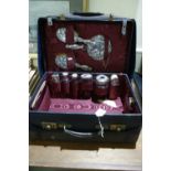 An Early 20th Century Travelling Case And Canvas Cover Fitted With Silver Mounted Bottles And