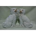 A Pair Of Staffordshire Pottery White Seated Dogs