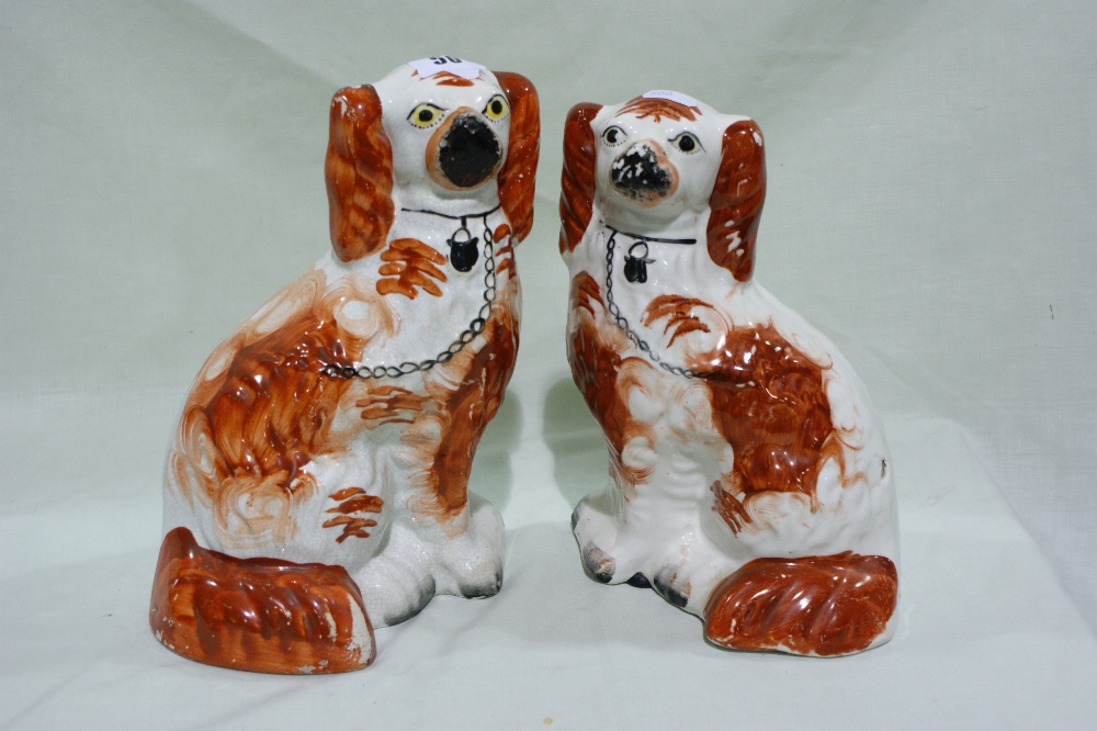 A Pair Of Staffordshire Pottery Red And White Seated Dogs