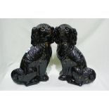 A Pair Of Staffordshire Pottery Jackfield Seated Dogs