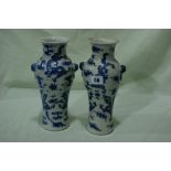 A Pair Of Circular Based Chinese Blue And White Dragon Decorated Vases