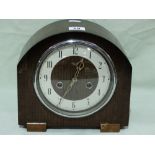 An Early 20th Century Polished Mantle Clock With Circular Silvered Dial