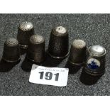 Five Silver Thimbles Together With A Pewter Thimble