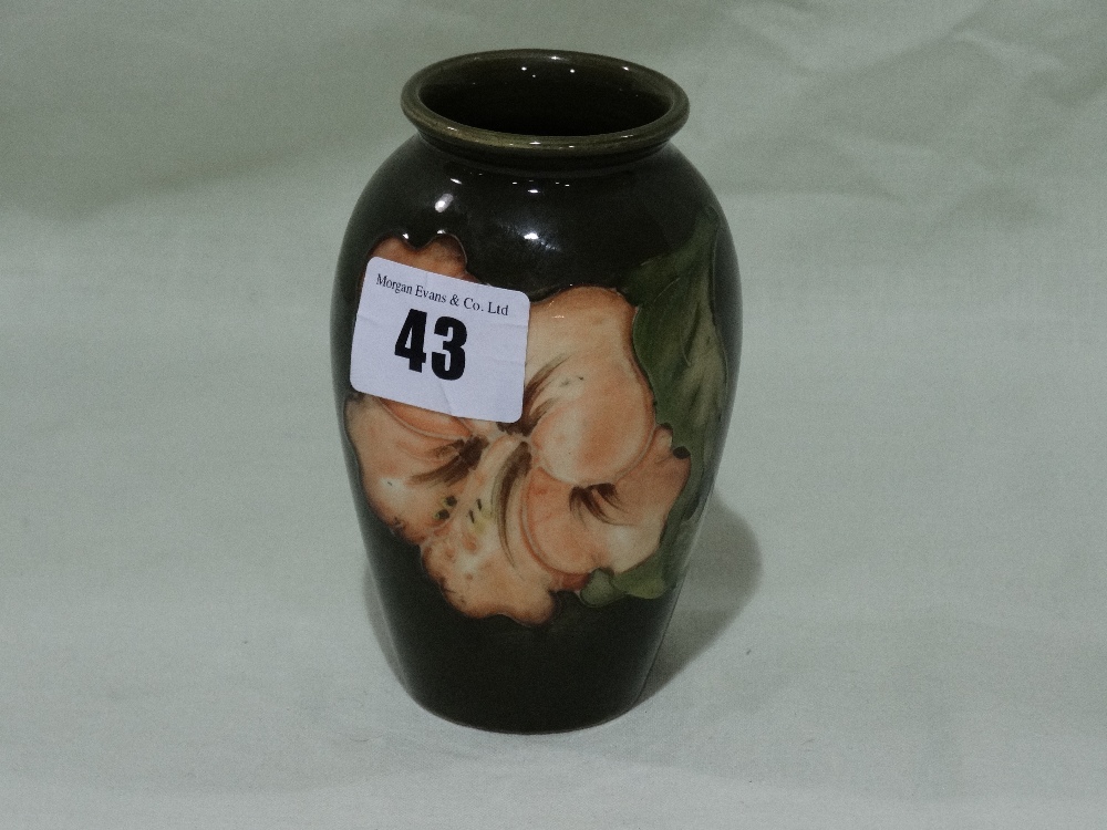 A Circular Based Green Ground Floral Decorated Moorcroft Pottery Vase, 4" High