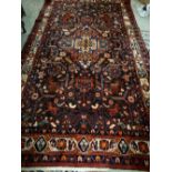 A Red Ground Woollen Rug Of Stylised Design