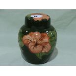 A Signed Green Ground Moorcroft Pottery Hibiscus Pattern Ginger Jar And Cover