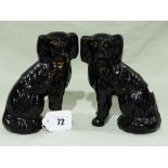 A Pair Of Staffordshire Pottery Jackfield Seated Dogs With Separate Front Legs