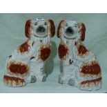 A Pair Of Staffordshire Pottery Red And White Seated Dogs
