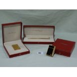 A Boxed Dupont Of Paris Gold Plated And Black Enamel Lighter Together With A Boxed Dupont Gold