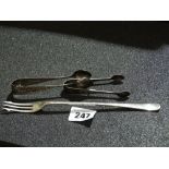 A Silver Pickle Fork Together With Two Silver Sugar Grips