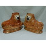 A Pair Of Staffordshire Pottery Models Of Reclining Lions With Inset Glass Eyes