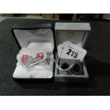 Two Pink Stone Dress Rings Together With A Pair Of Earrings