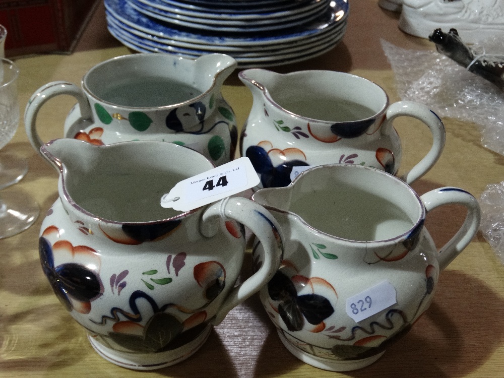 Four Gaudy Welsh Pottery Milk Jugs