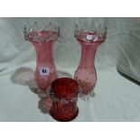 A Pair Of Cranberry Tinted Flower Vases Together With A Further Cranberry Glass Vase