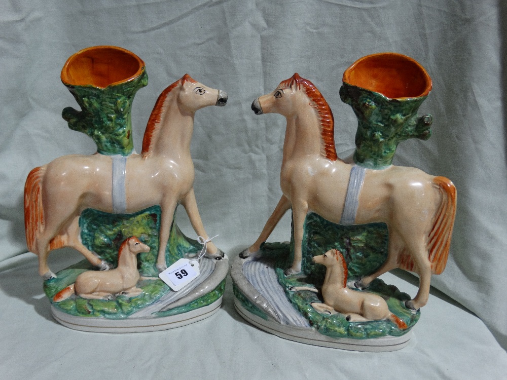 A Pair Of Staffordshire Pottery Horse And Foal Spill Holder Groups