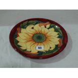A Circular Moorcroft Pottery Charger With Sunflower Centre