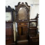 An Antique Oak And Mahogany Encased Long Case Clock Enclosing An Arched Painted Dial With Eight