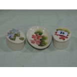 Three Small Cream Ground Moorcroft Pottery Dishes And Boxes