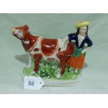 A Staffordshire Pottery Cow And Milk Maid Creamer