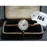 A Nine Carat Gold Encased Ladies Wrist Watch With Expanding Bracelet And Circular Enamel Dial