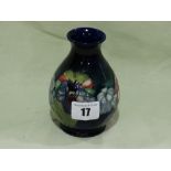 A Circular Based Moorcroft Pottery Blue Ground Floral Decorated Globular Vase