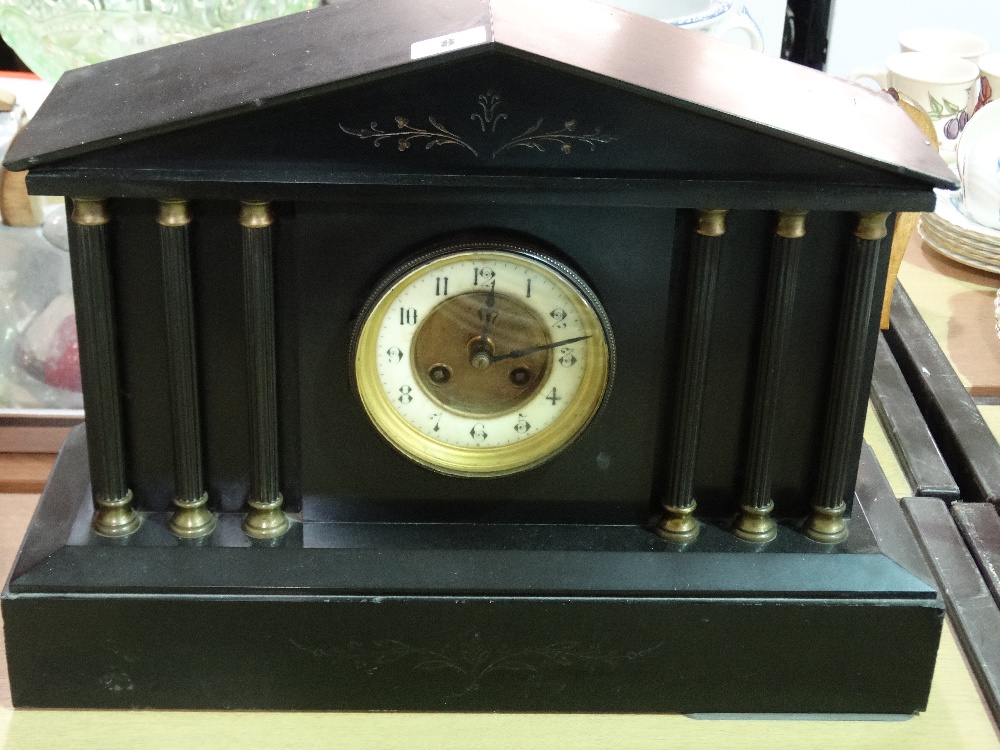 A Victorian Black Marble Encased Mantel Clock With Circular Enamel Dial