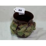 A Majolica Glazed Pottery Cream Jug With Relief Vine And Grape Band