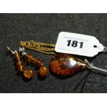 An Amber Stone Pendant On A Fine Link Chain Together With A Pair Of Amber Set Earrings