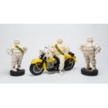 MICHELIN: A pair of Bibendum figurines mounted on Michelin replica tyres; 1 in plaster; 1 resin;