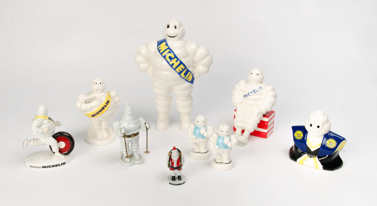 MICHELIN: A collection of ceramic Bibendum figurines (9 items).