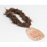 A Carved Pearl Shell with human hair belt (Riji Jakoli)  Western Australia (early-mid twentieth