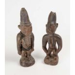 Two west African carved and pigmented Ere Ibeji femail figures, 20th century  Two west African