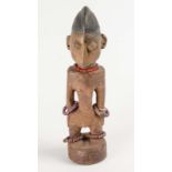 A west African carved and pigmented male Ere Ibeji figure, 20th century  A west African carved and