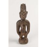 A West African carved and pigmented Ere Ibeji figure, 20th century  A West African carved and