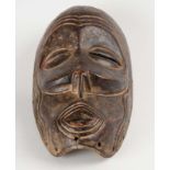 An Indonesian carved ceremonial mask, mid 20th century  An Indonesian carved ceremonial mask, mid