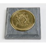 MICHELIN: A  brass medal depicting the image of the first band leggings with the text "Michelin &