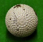 Red dot'The Colonel' bramble pattern rubber core golf ball with the patent number to the opposite