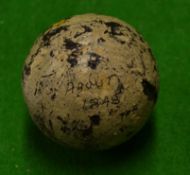 An early smooth gutty golf ball with some strike marks but in good round condition and some original