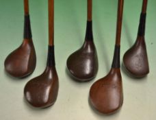 5x Stained persimmon woods a driver by A Davey^ 2x brassies one by Fred Sanders (bent shaft) and