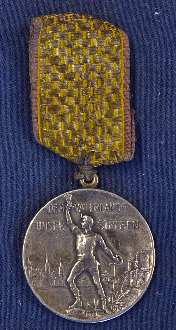 1903 White metal fencing medal circular in shape^ with a triumphant figure to the front and'Dem