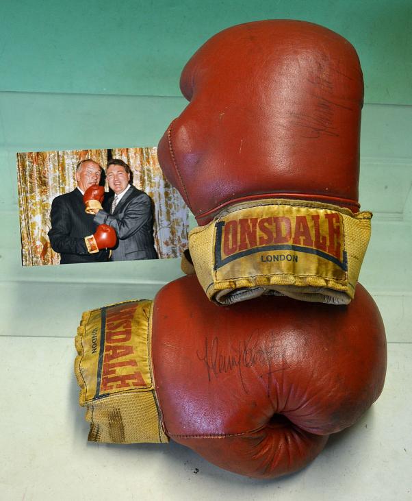 Rare pair of fight worn Henry Cooper boxing gloves signed by Cooper and Ali - comprising a red and