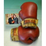 Rare pair of fight worn Henry Cooper boxing gloves signed by Cooper and Ali - comprising a red and