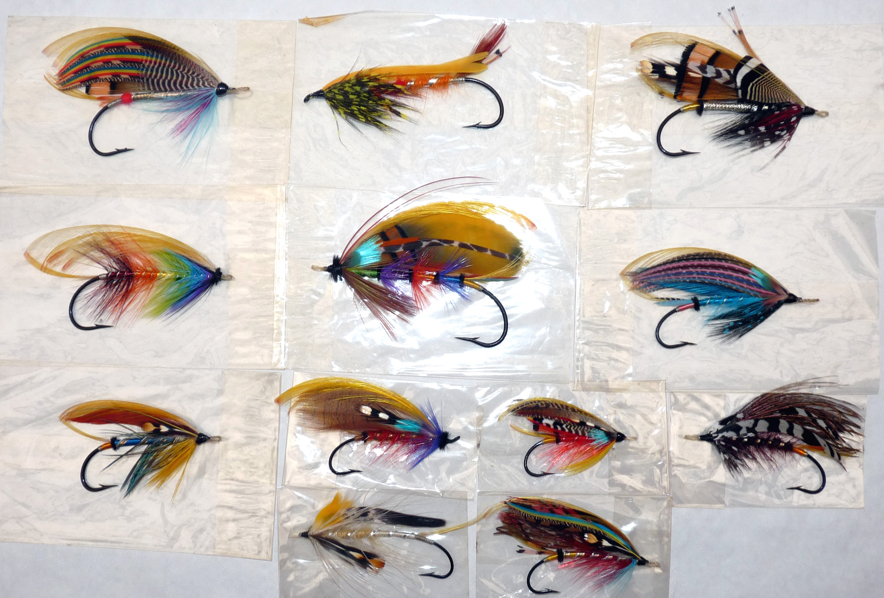 FLIES: (12) Collection of traditionally dressed gut eye salmon flies on black irons, various