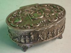 A Victorian Silver Trinket Box of oval form, the hinged lid boldly embossed with birds, trees and