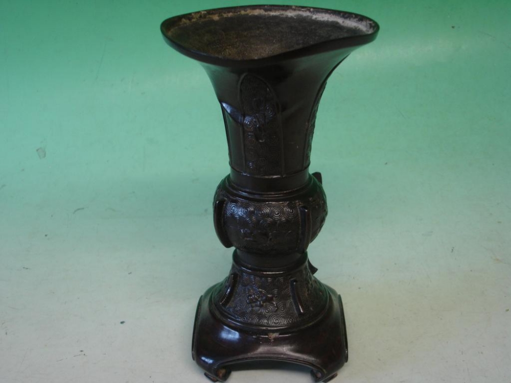 A Japanese Bronze Vase Meiji. With flared rim, decorated with spiral roundals and animals, raised in