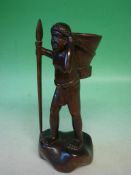 An Ethnic Carved Hardwood Figure A man with a basket and spear. 11" high