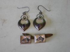 A Pair of Silver Earrings Crescent form and set with a purple cabochon, together with a pair of