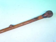 A Fruitwood Walking Cane The grip carved as head of George Washington, the shaft with five hound's