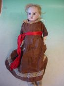 A German Child Doll Probably Armand Marseille for the French market. Bisque head with blonde wig,