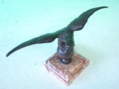 A Bronze Desk Weight Formed as an eagle with spread wings, raised on a specimen marble base.